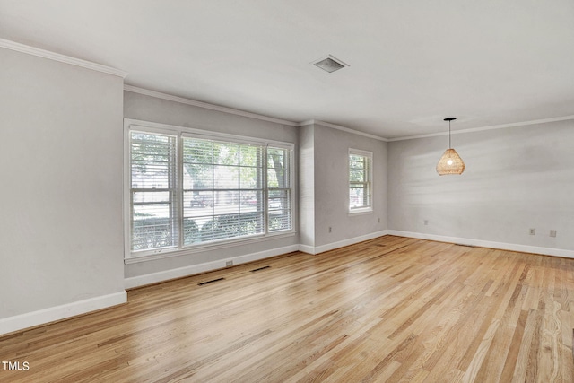 empty room with light hardwood / wood-style floors and crown molding