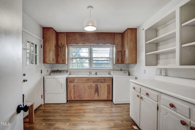 interior space with separate washer and dryer, cabinets, sink, and hardwood / wood-style flooring