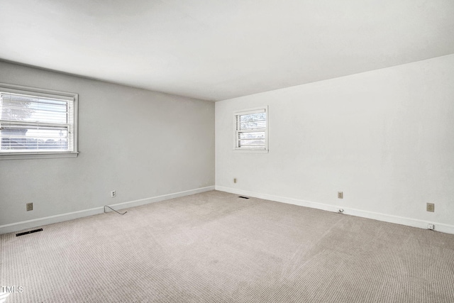 spare room with light carpet