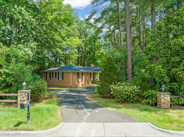 3006 Pump Station Ln, Durham, NC 27712 - ranch-style house featuring driveway and a chimney