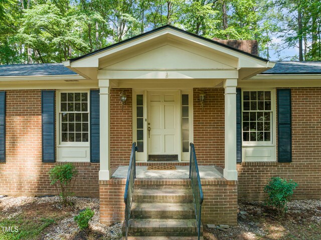 3006 Pump Station Ln, Durham, NC 27712 - doorway to property with brick siding and roof with shingles