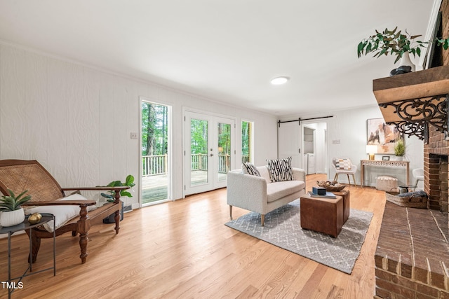 3006 Pump Station Ln, Durham, NC 27712 - living area featuring wood finished floors, ornamental molding, french doors, and a brick fireplace