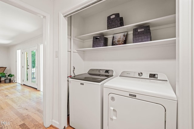 3006 Pump Station Ln, Durham, NC 27712 - laundry room with light wood-style floors and washing machine and clothes dryer