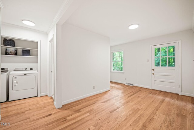 3006 Pump Station Ln, Durham, NC 27712 - foyer with washer and clothes dryer, light wood finished floors, and crown molding