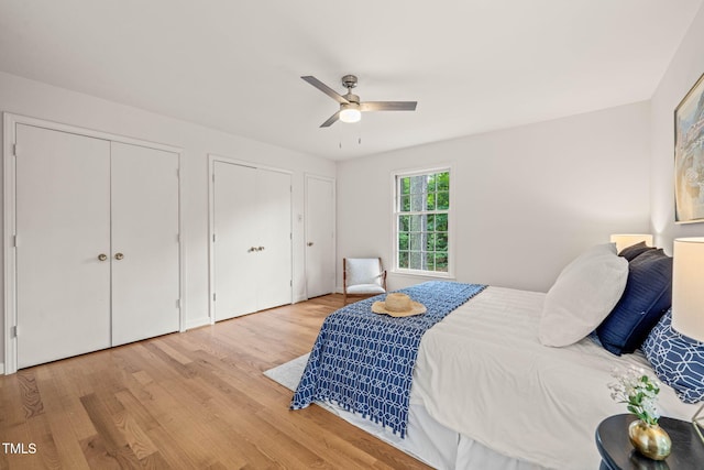 3006 Pump Station Ln, Durham, NC 27712 - bedroom featuring multiple closets, wood finished floors, and a ceiling fan