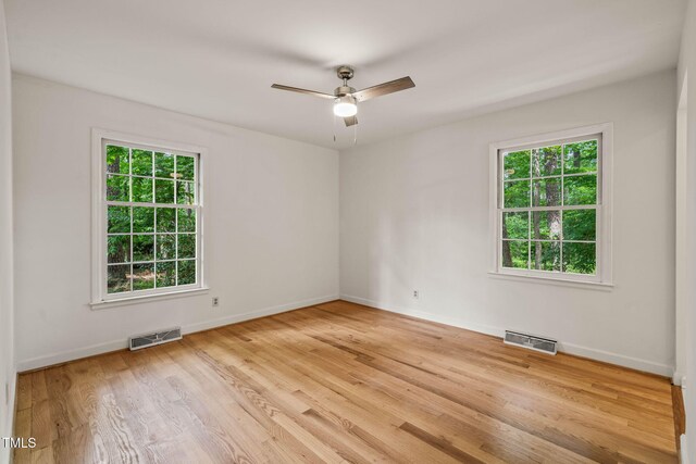 3006 Pump Station Ln, Durham, NC 27712 - spare room with healthy amount of natural light, wood finished floors, and a ceiling fan