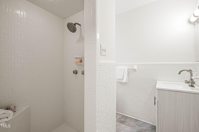 3006 Pump Station Ln, Durham, NC 27712 - bathroom featuring vanity, a tile shower, tile walls, and wainscoting