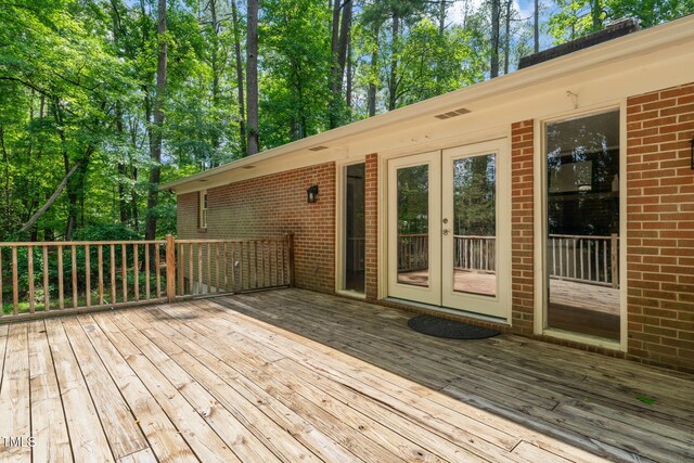 3006 Pump Station Ln, Durham, NC 27712 - wooden deck with french doors and view of scattered trees