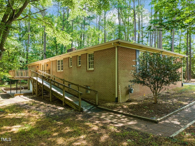 3006 Pump Station Ln, Durham, NC 27712 - view of property exterior with brick siding, a deck, and stairway
