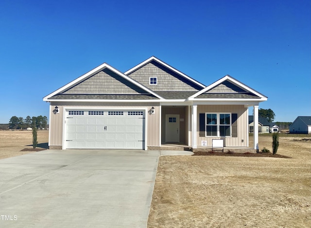 craftsman-style home featuring a porch and a garage