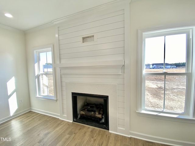 details with hardwood / wood-style flooring and ornamental molding