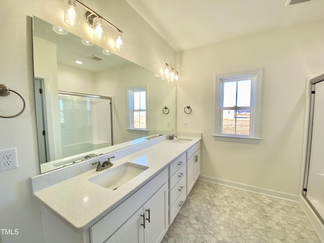 bathroom featuring tile patterned flooring, an enclosed shower, and vanity