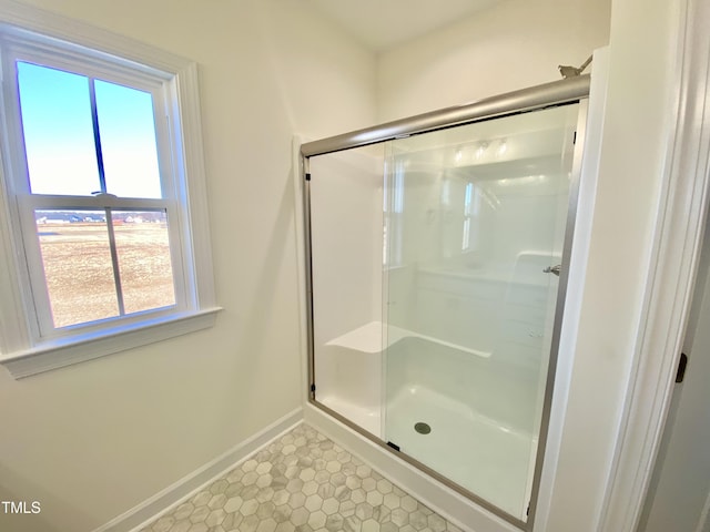 bathroom featuring a shower with door