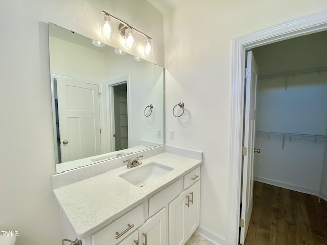 bathroom with vanity and hardwood / wood-style flooring