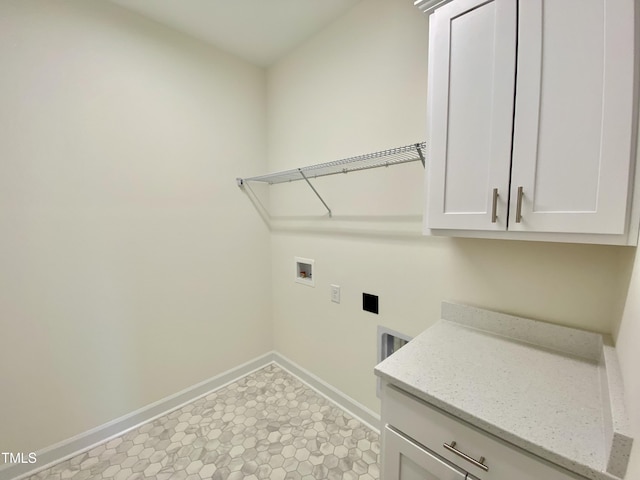 laundry room featuring electric dryer hookup, hookup for a washing machine, and cabinets