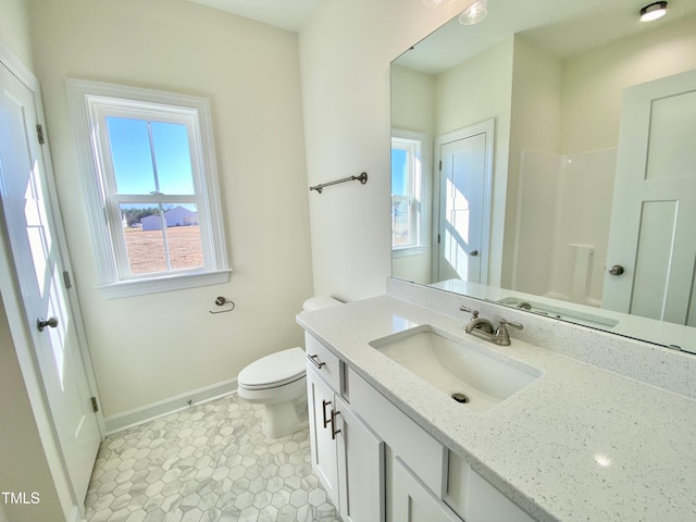 bathroom with toilet, a shower, vanity, and tile patterned flooring