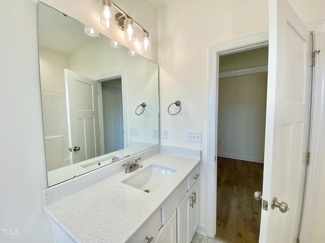 bathroom with hardwood / wood-style floors and vanity