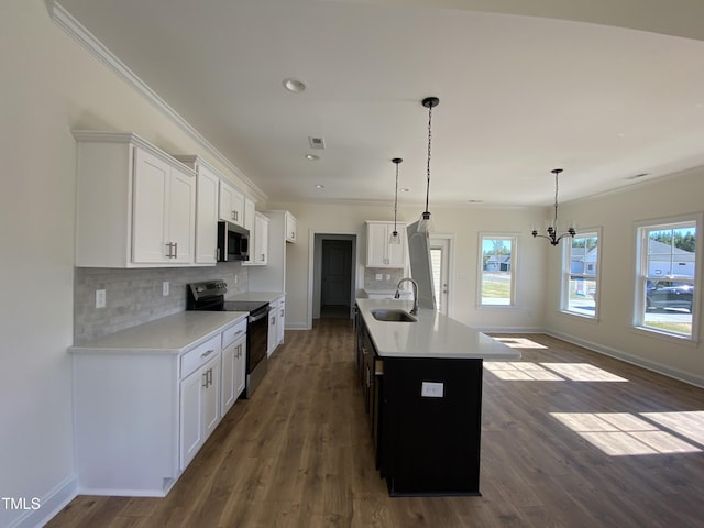 kitchen with backsplash, ornamental molding, stainless steel appliances, and a sink