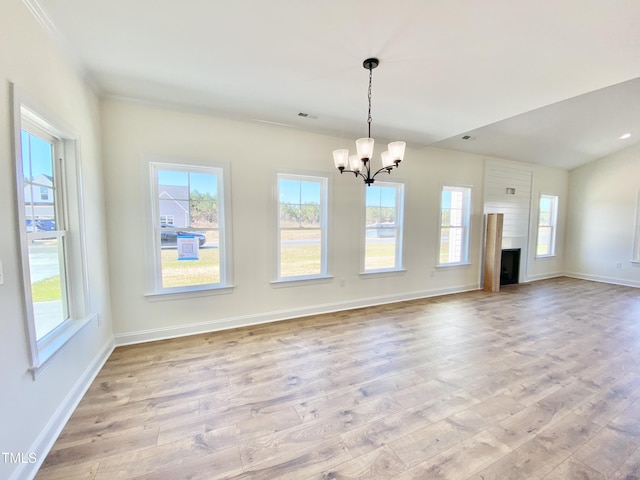 unfurnished dining area with a chandelier, wood finished floors, and a wealth of natural light