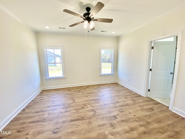 empty room featuring ornamental molding, plenty of natural light, and visible vents