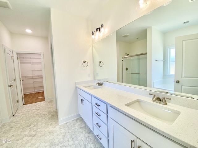 full bathroom featuring a garden tub, visible vents, a sink, and a stall shower