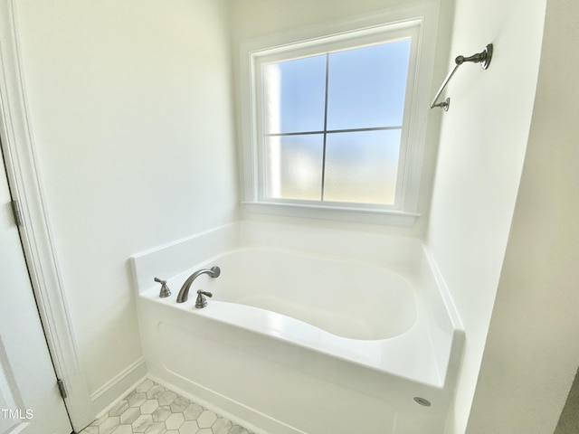 bathroom featuring tile patterned floors, a garden tub, and a healthy amount of sunlight
