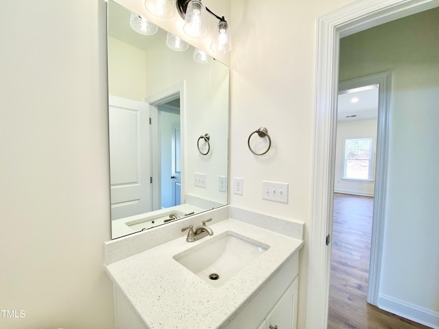 bathroom with vanity and wood finished floors