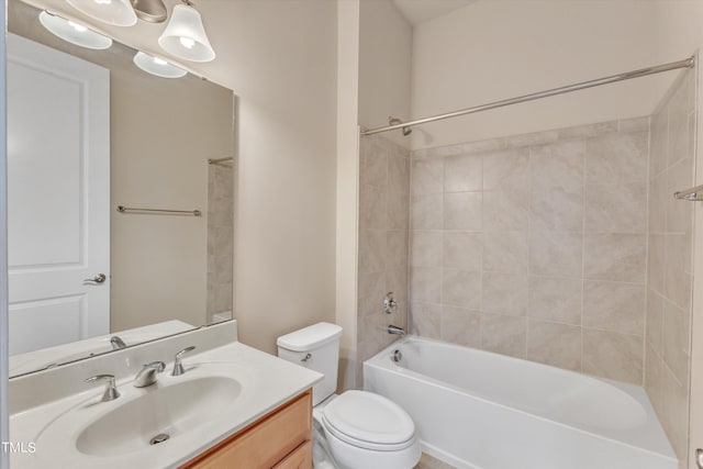 full bathroom with vanity, tiled shower / bath combo, and toilet