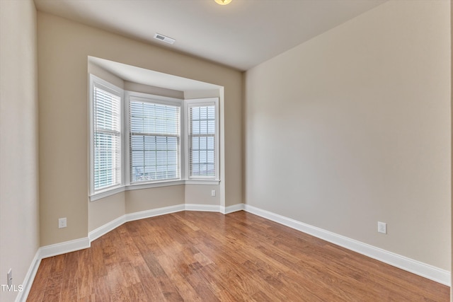 spare room with light hardwood / wood-style floors