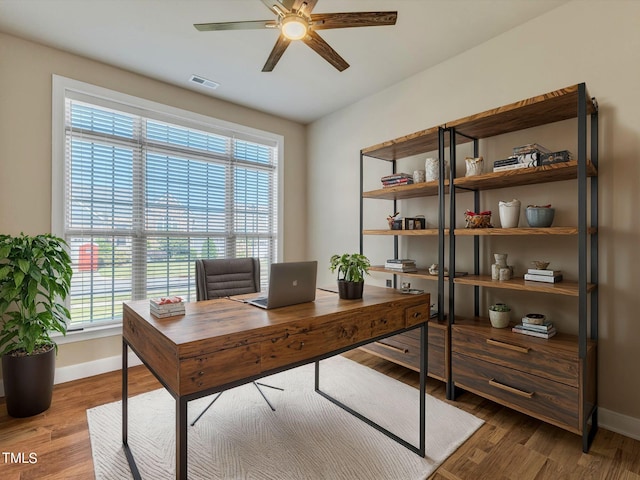 office featuring ceiling fan, hardwood / wood-style floors, and a healthy amount of sunlight