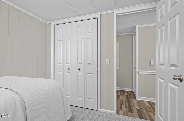4193 Ji Oakes Rd, Bullock, NC 27507 - bedroom with a closet, a decorative wall, wood finished floors, baseboards, and crown molding