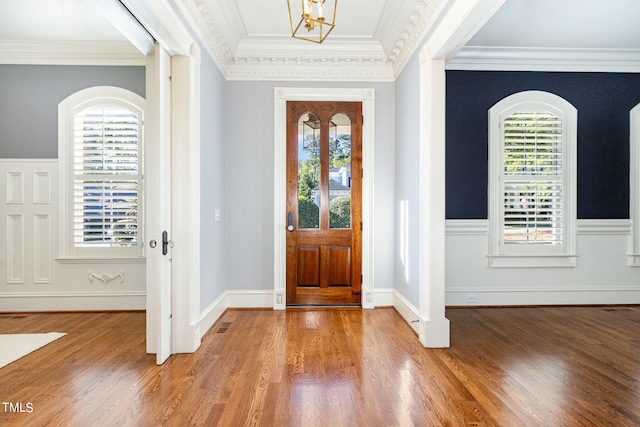 entrance foyer featuring plenty of natural light, hardwood / wood-style floors, and crown molding