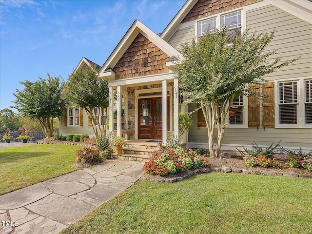 view of front of home with a front yard and covered porch