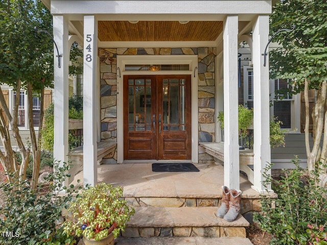 doorway to property featuring french doors and covered porch