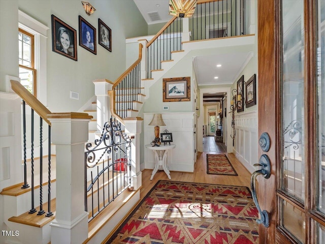 foyer featuring hardwood / wood-style floors and crown molding