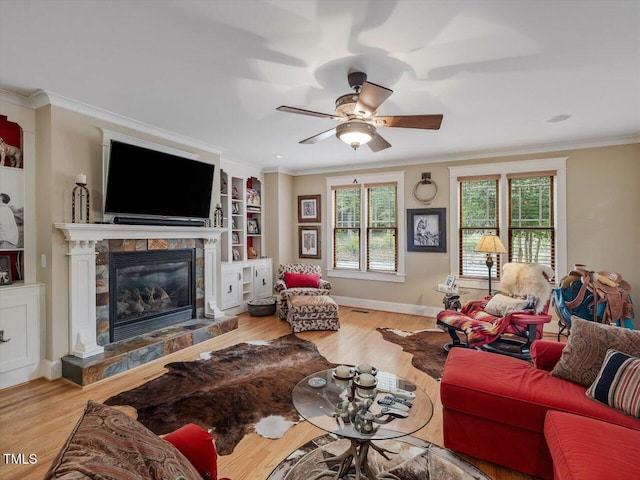 living room with crown molding, light wood-type flooring, and ceiling fan