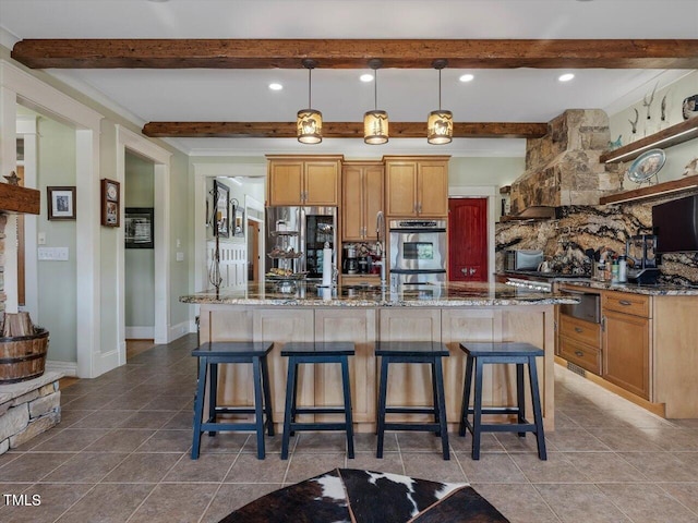 kitchen featuring double oven, beam ceiling, hanging light fixtures, a kitchen bar, and light stone counters