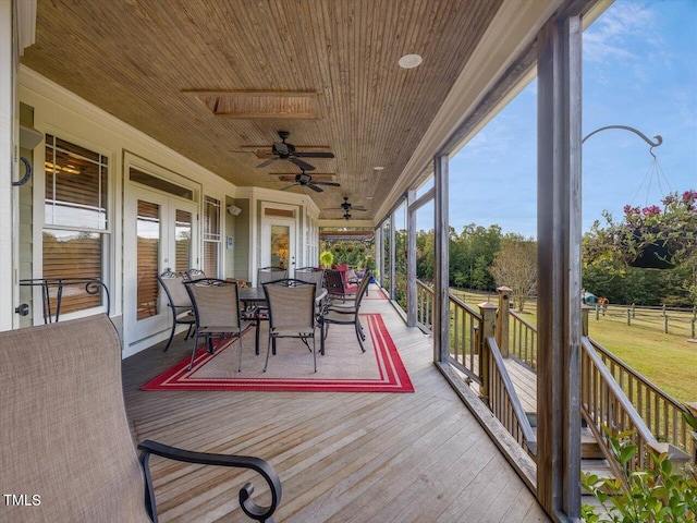 sunroom / solarium with french doors, wooden ceiling, and ceiling fan