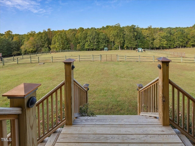 deck featuring a rural view and a yard