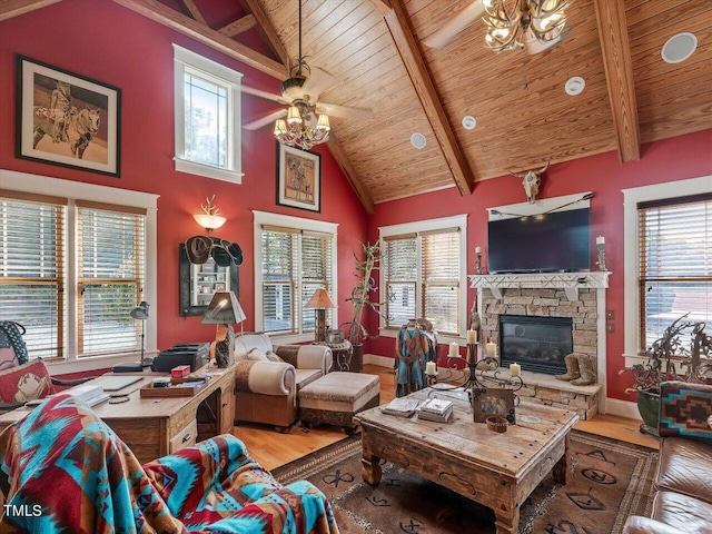 living room with a wealth of natural light, beamed ceiling, and hardwood / wood-style flooring