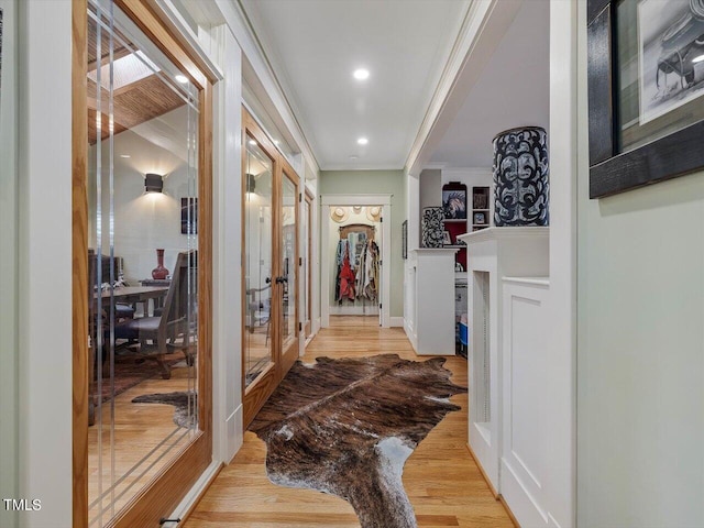 hallway featuring light hardwood / wood-style flooring and ornamental molding