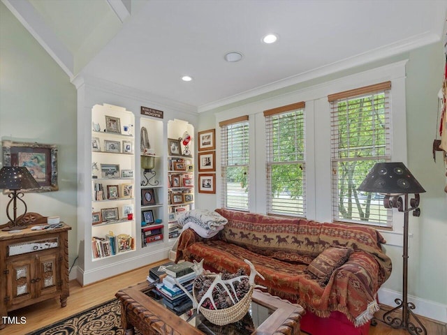 living room with light hardwood / wood-style flooring and crown molding