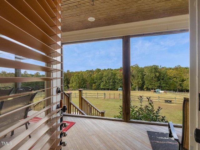 wooden deck featuring a yard and a rural view