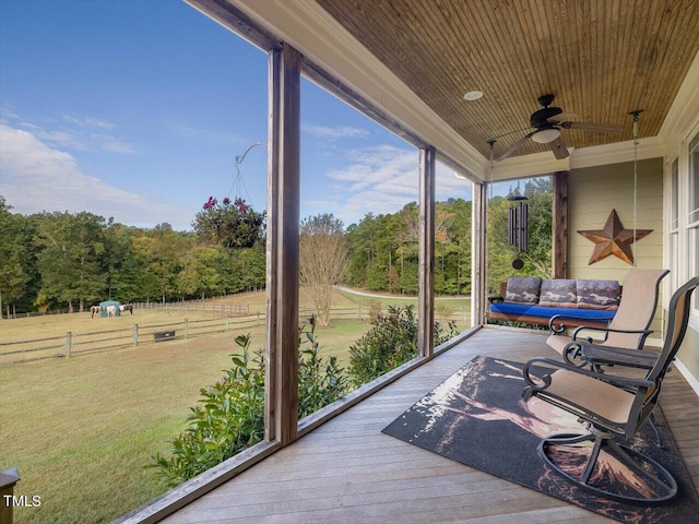 sunroom with ceiling fan and wooden ceiling