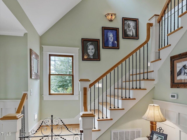 staircase featuring lofted ceiling