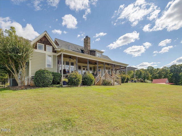 rear view of property featuring central AC, a porch, a lawn, and ceiling fan