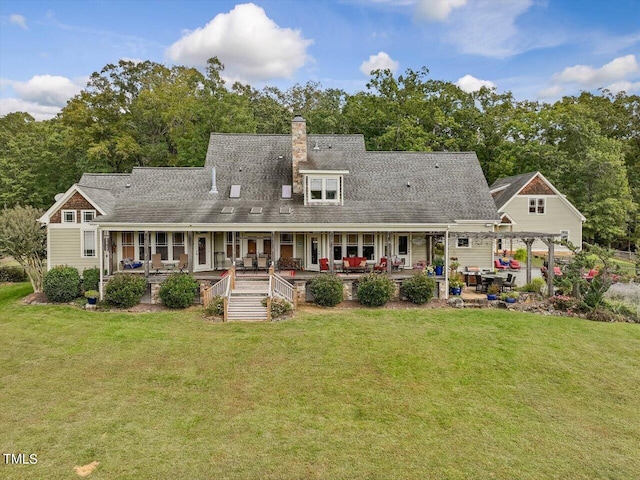 rear view of property with a deck and a lawn