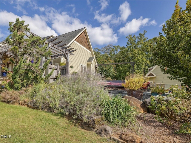 view of side of home with a yard