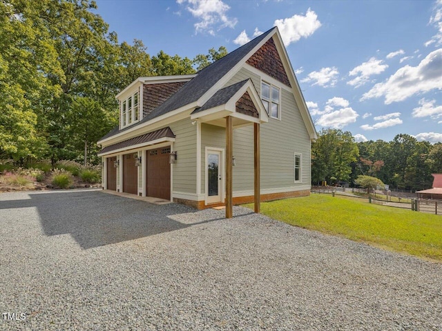 view of front of home featuring a front lawn and a garage