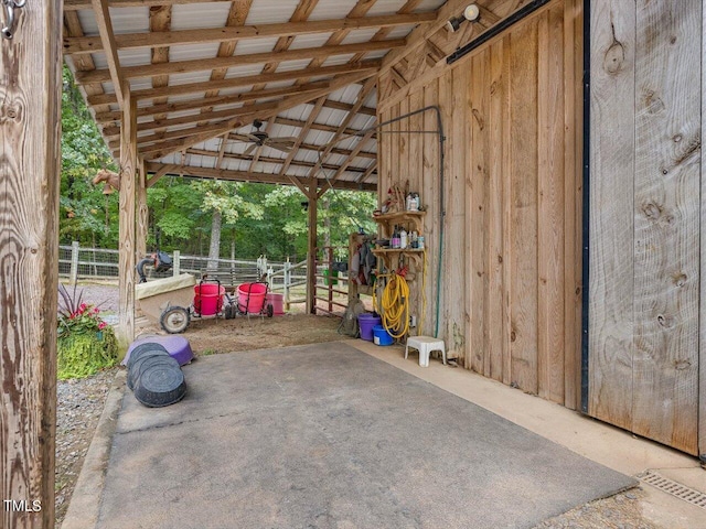 view of patio with an outdoor structure and ceiling fan